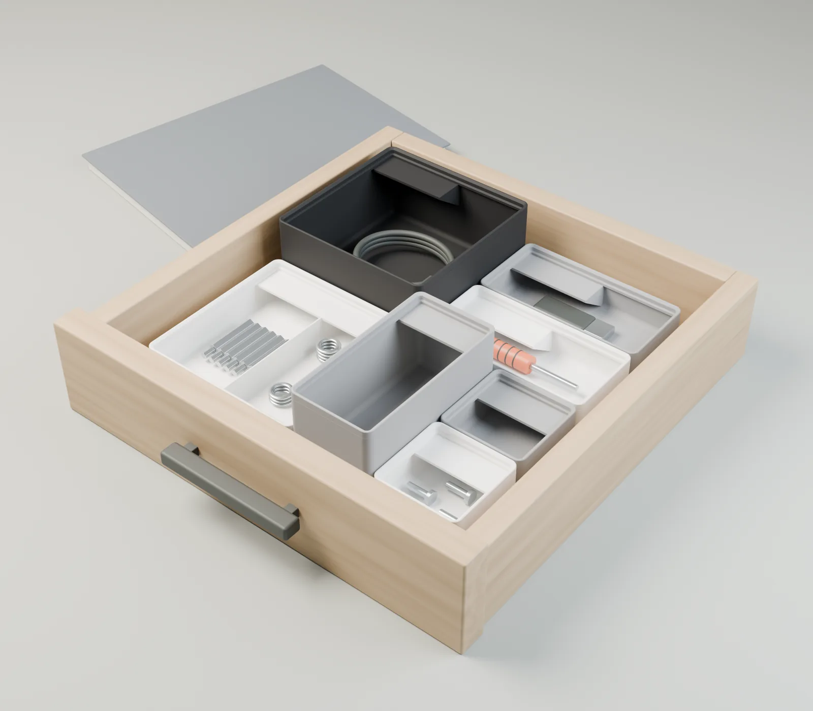 Visualisation du produit : des boîtes modulaires avec de petits outils et un câble dans un tiroir en bois